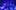 A forest ravine at night lit with bright blue and purple lights.